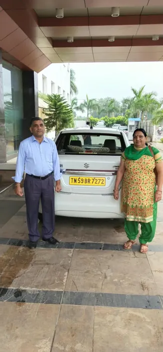 Traveller beside a rental vehicle